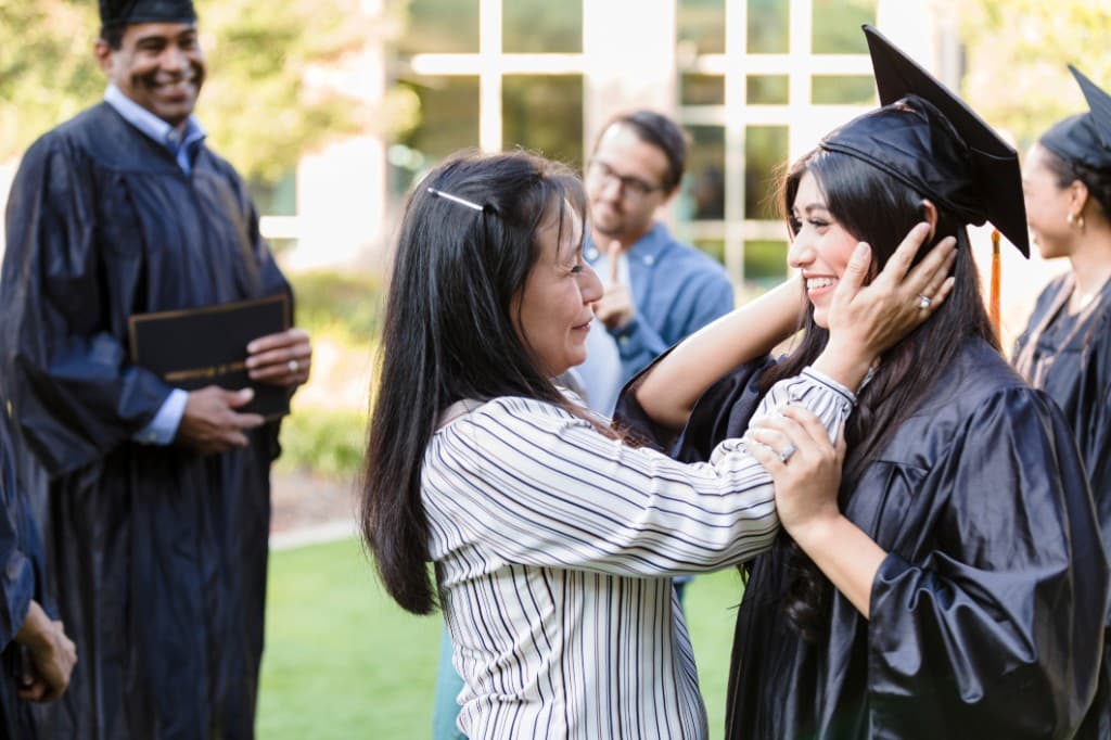 Graduate with family at graduation ceremony